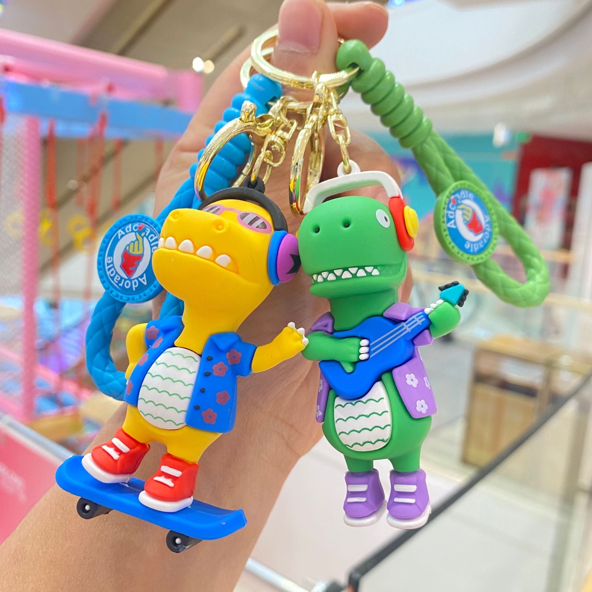 🦖 Cute Dinosaur Keychain – Music & Skateboard Edition