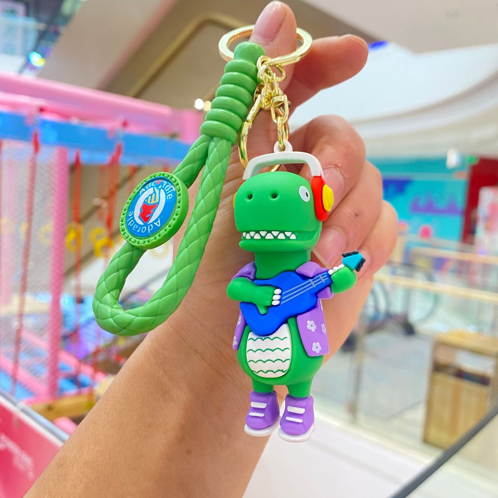 🦖 Cute Dinosaur Keychain – Music & Skateboard Edition