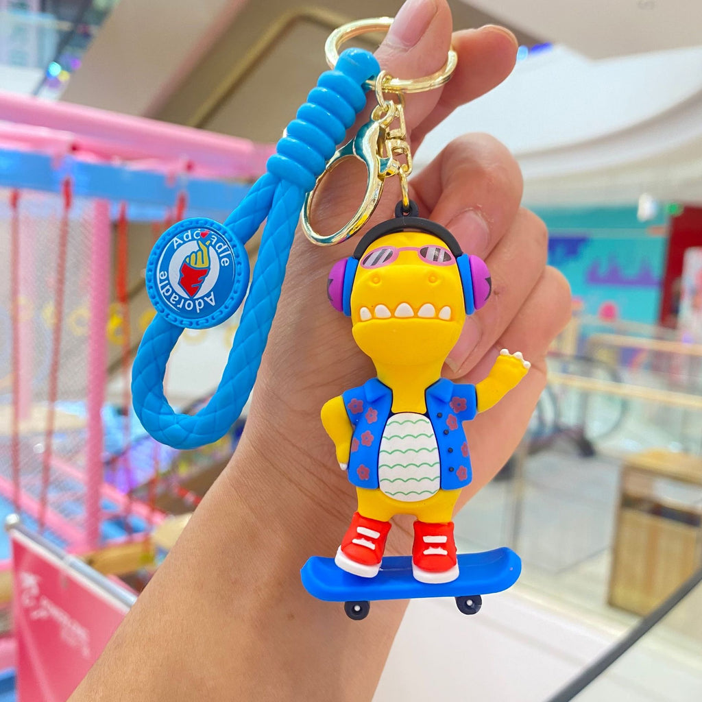 🦖 Cute Dinosaur Keychain – Music & Skateboard Edition