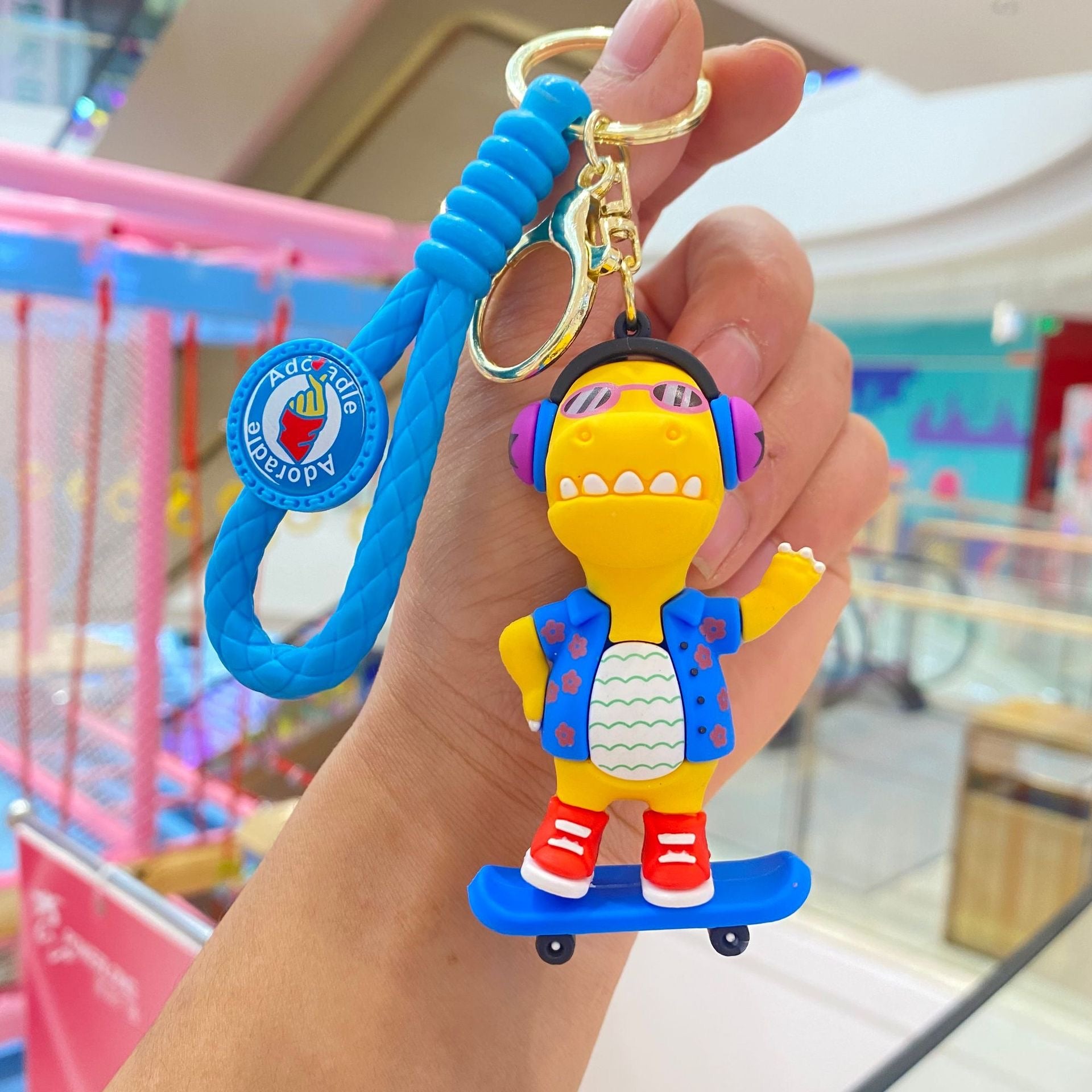 🦖 Cute Dinosaur Keychain – Music & Skateboard Edition